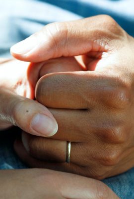 Image of doctor holding hands with patient