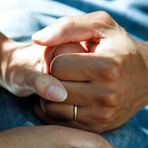 Image of doctor holding hands with patient