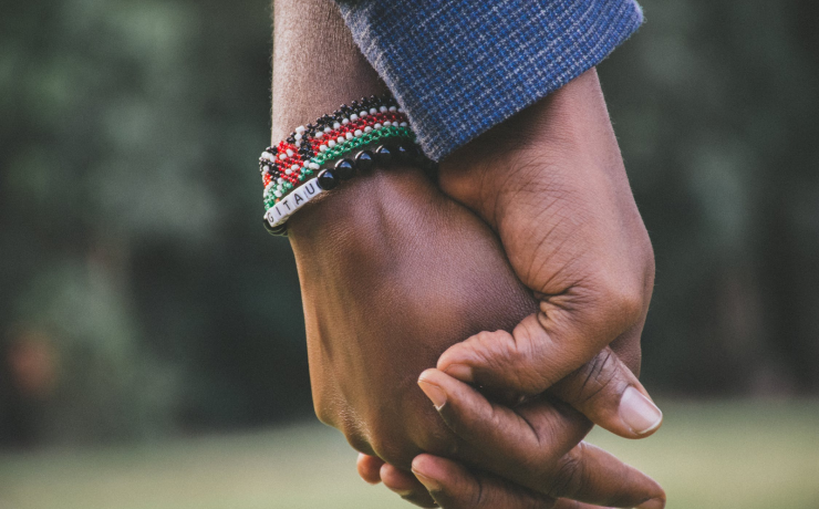 Image of two people holding hands