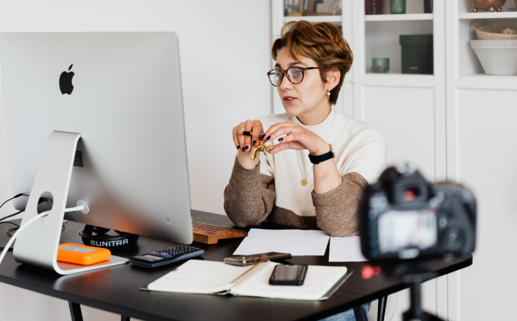 Women at desk, virtual meeting